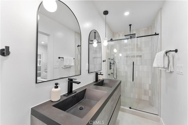 bathroom featuring vanity and a shower with shower door