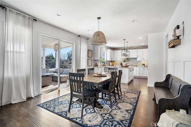 dining space with dark wood-type flooring