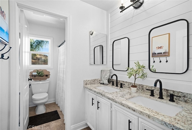 bathroom featuring vanity, toilet, and tile patterned flooring