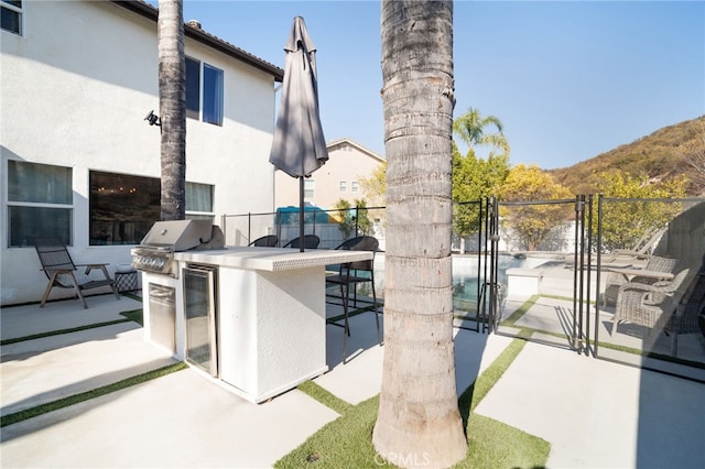 view of patio / terrace with area for grilling, grilling area, and exterior bar