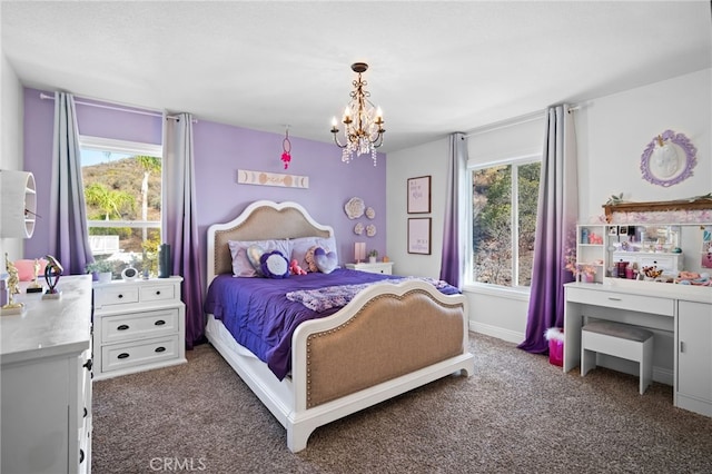 carpeted bedroom featuring a notable chandelier