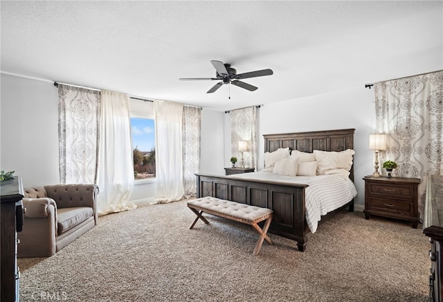 carpeted bedroom featuring a textured ceiling and ceiling fan