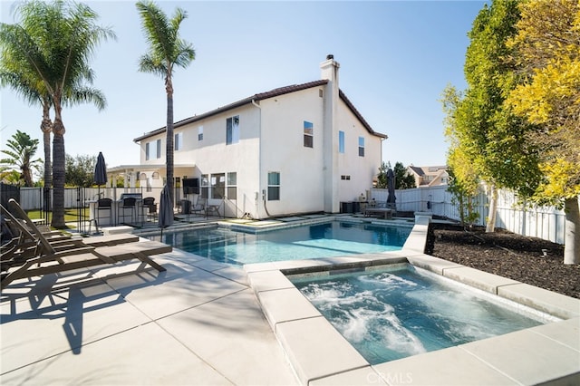 view of pool featuring an in ground hot tub and a patio