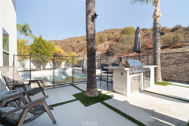 view of patio with an outdoor kitchen and area for grilling