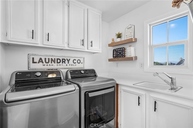 laundry room with sink, cabinets, and washer and dryer