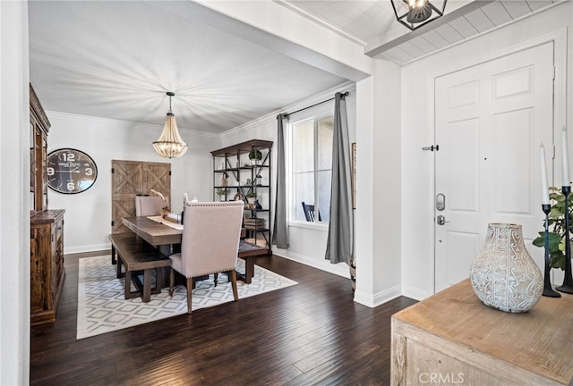 dining area featuring an inviting chandelier, dark wood-type flooring, and ornamental molding