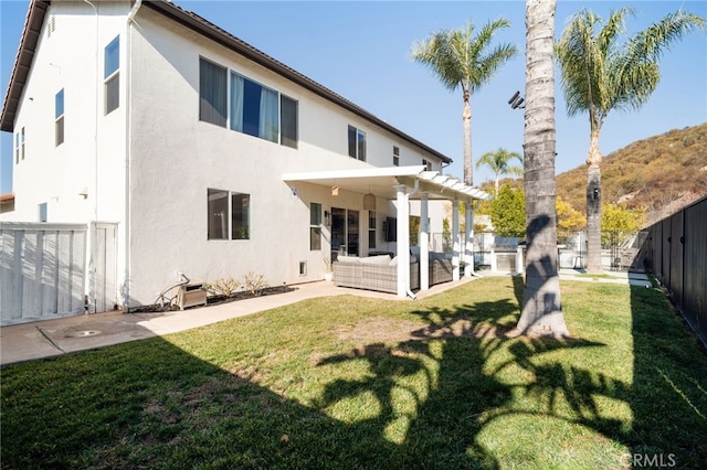 back of house with a pergola, a lawn, and outdoor lounge area