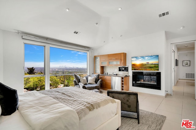 tiled bedroom featuring refrigerator and vaulted ceiling