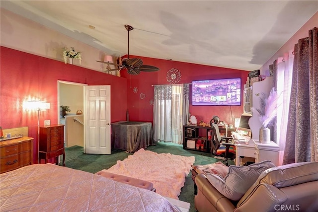 bedroom with ceiling fan, lofted ceiling, and dark colored carpet