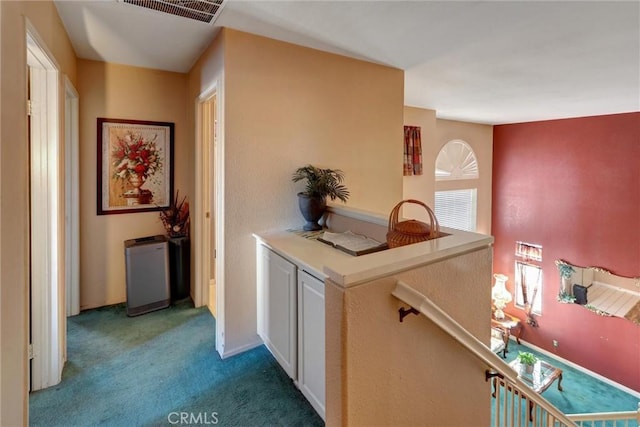 hallway with carpet flooring