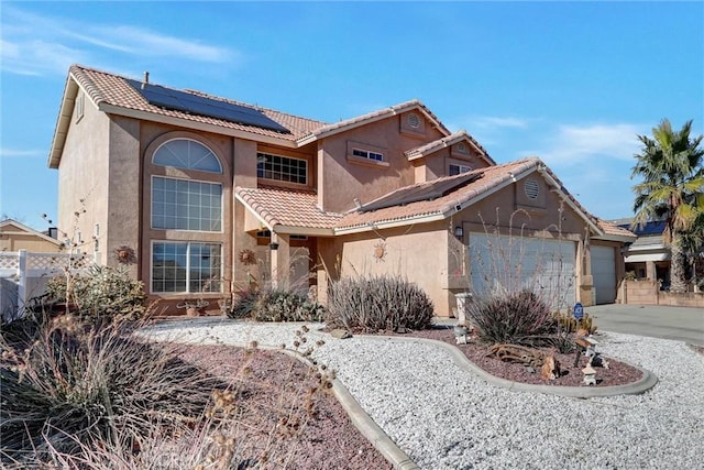 view of front of home with a garage and solar panels