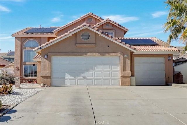 view of front facade with solar panels and a garage