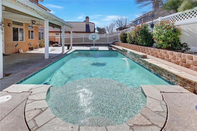 view of pool featuring pool water feature, ceiling fan, and a patio area