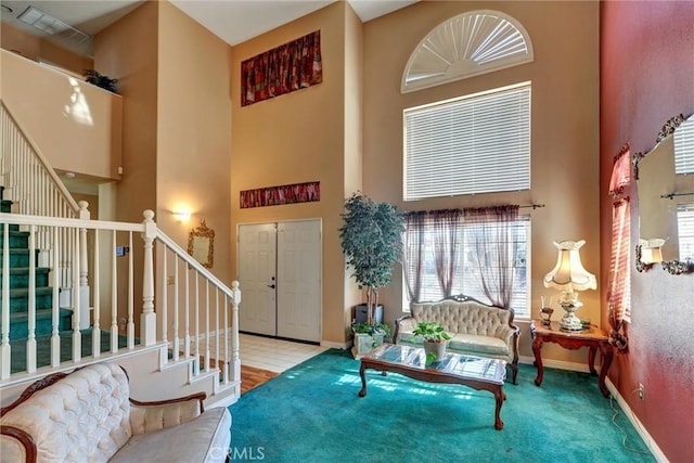 carpeted entrance foyer with a wealth of natural light and a high ceiling