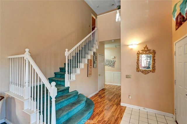 staircase featuring tile patterned flooring