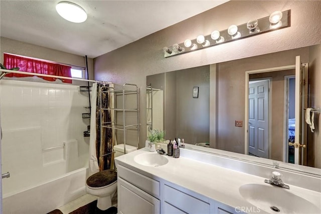 full bathroom featuring shower / bath combo, vanity, and toilet