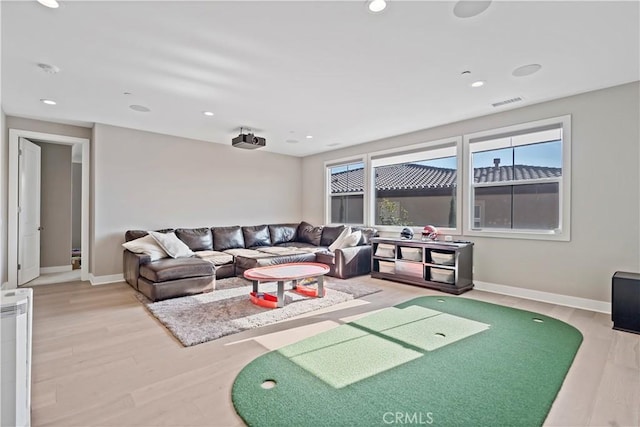 living room with hardwood / wood-style floors and golf simulator