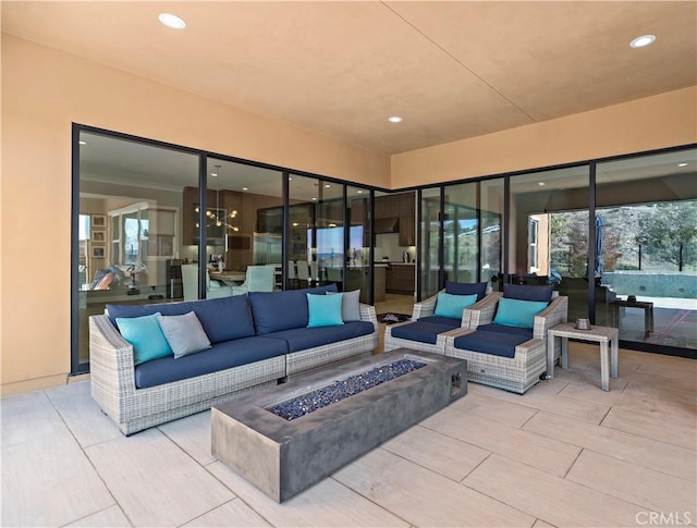 view of patio / terrace featuring an outdoor living space with a fire pit