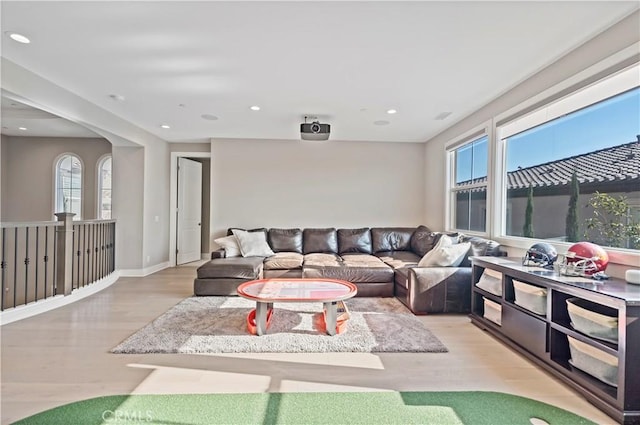 living room with a wealth of natural light and light hardwood / wood-style flooring