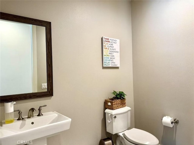 bathroom featuring sink and toilet