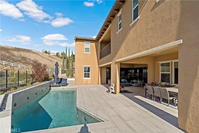 view of pool featuring a mountain view and a patio area