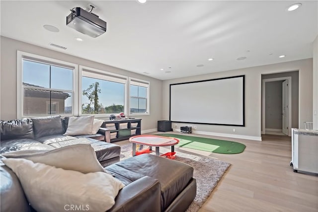 cinema room with light wood-type flooring