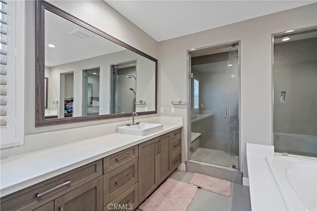 bathroom with tile patterned flooring, vanity, and plus walk in shower