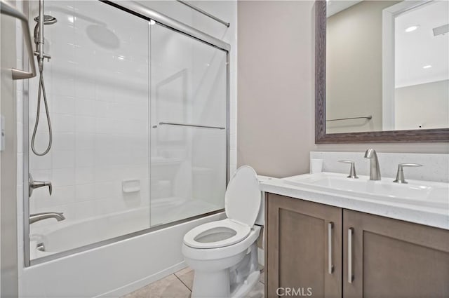 full bathroom with vanity, toilet, combined bath / shower with glass door, and tile patterned flooring