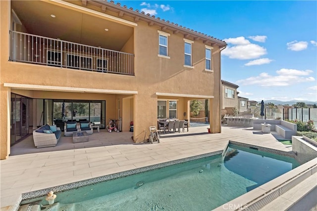 rear view of house with a patio and an outdoor hangout area