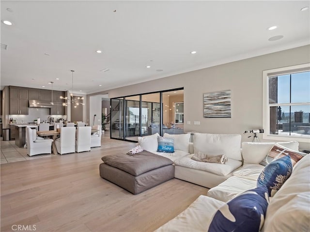 living room featuring light hardwood / wood-style flooring and a notable chandelier