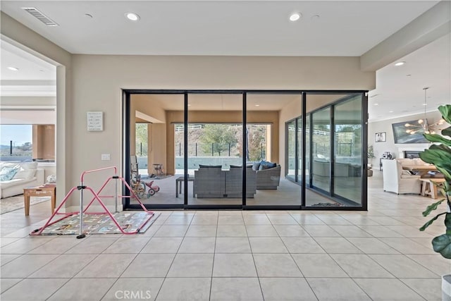 doorway with plenty of natural light and light tile patterned flooring