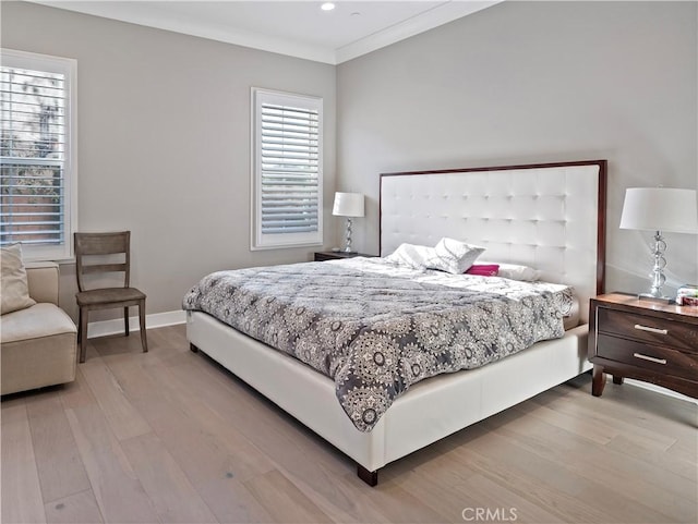 bedroom featuring hardwood / wood-style floors and crown molding