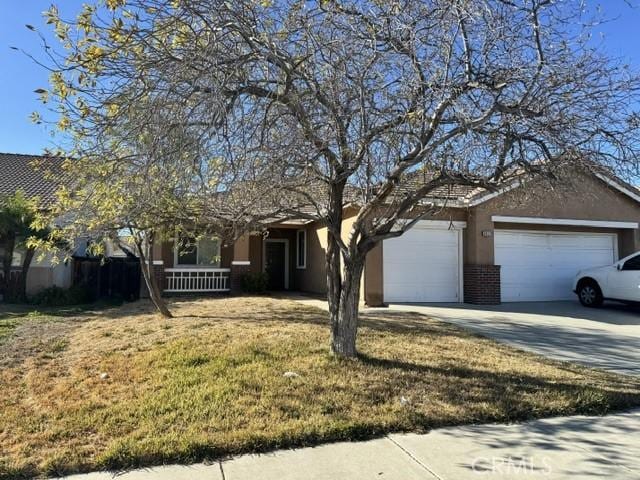 single story home with a front yard and a garage