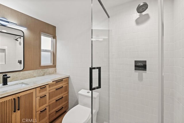 bathroom featuring vanity, toilet, and walk in shower