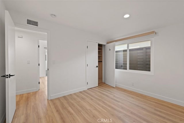 spare room featuring light hardwood / wood-style flooring