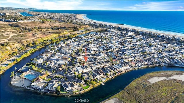 drone / aerial view featuring a view of the beach and a water view