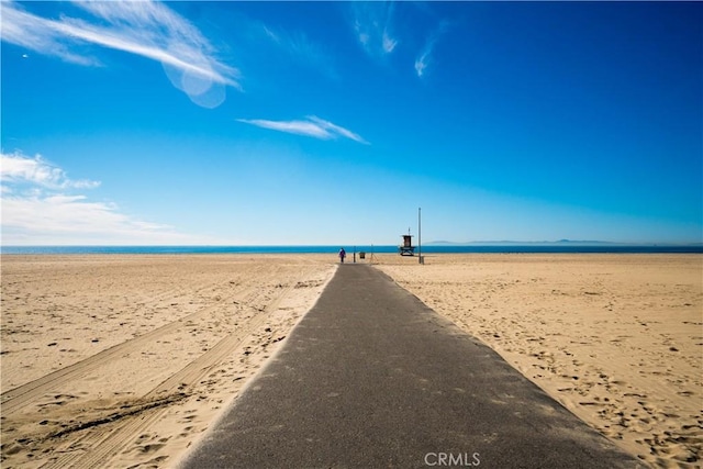 surrounding community featuring a beach view and a water view