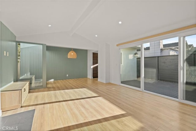 interior space featuring wood-type flooring and lofted ceiling