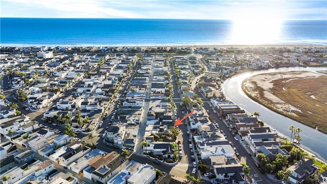 birds eye view of property featuring a water view and a view of the beach