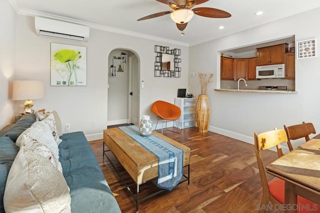 living room featuring ceiling fan, sink, dark hardwood / wood-style floors, a wall unit AC, and crown molding