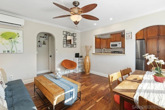 interior space featuring a wall mounted air conditioner, dark hardwood / wood-style flooring, ceiling fan, and ornamental molding