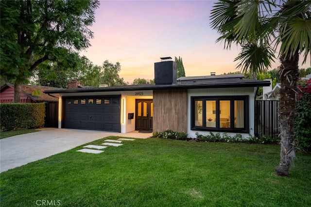 view of front of property with a lawn and a garage