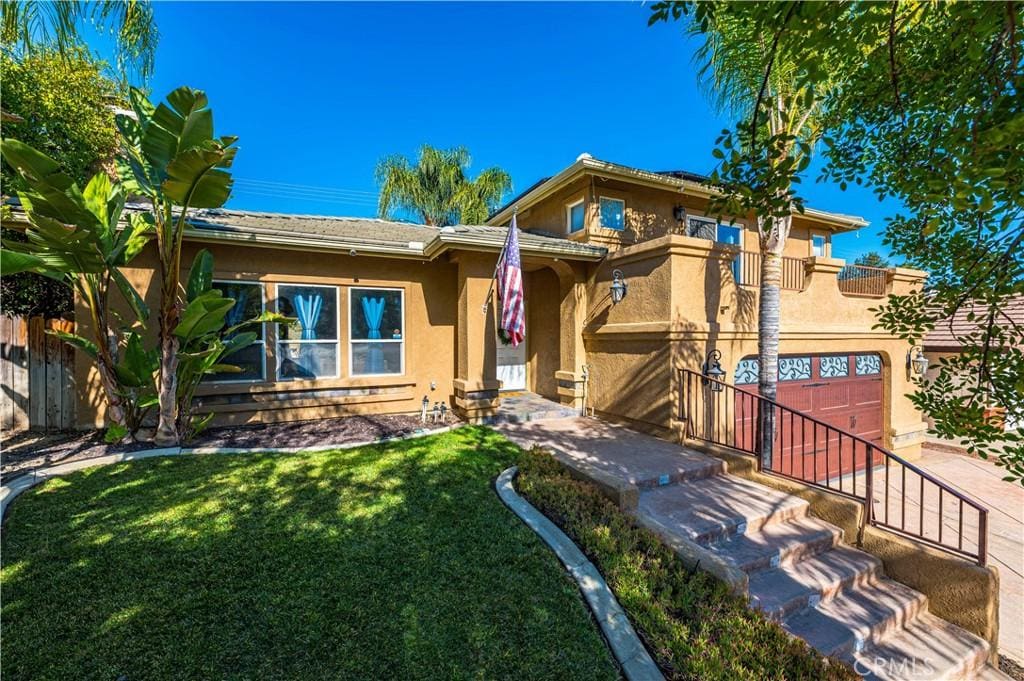 view of front of house with a front yard and a garage