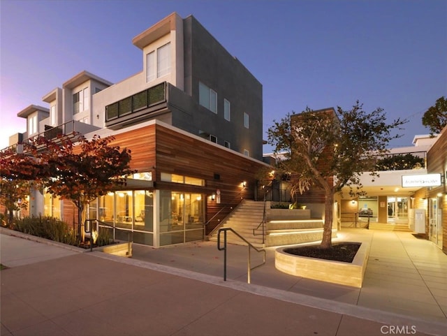 view of outdoor building at dusk