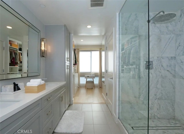 bathroom featuring vanity, tile patterned flooring, and a shower with door