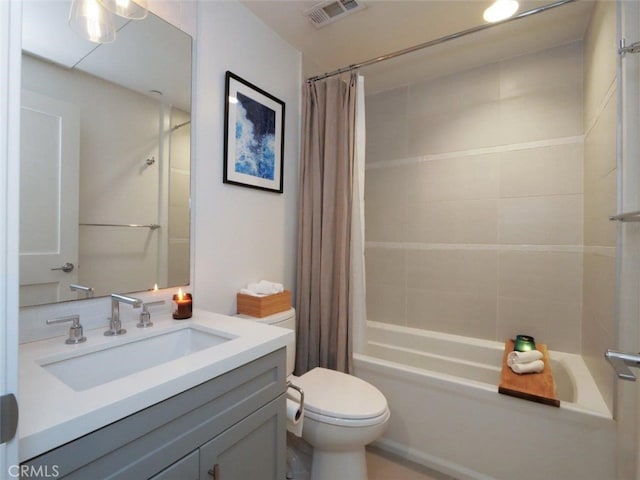 full bathroom with vanity, shower / tub combo with curtain, and toilet