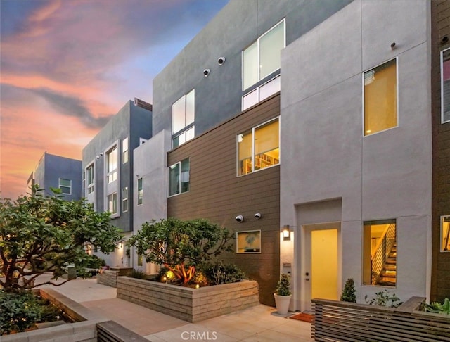 view of outdoor building at dusk