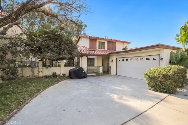 mediterranean / spanish house with a garage