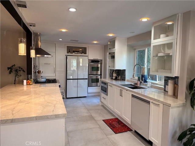 kitchen featuring dishwasher, white cabinetry, double oven, white fridge, and hanging light fixtures