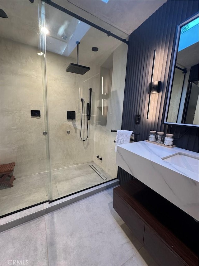 bathroom featuring vanity and a shower with door